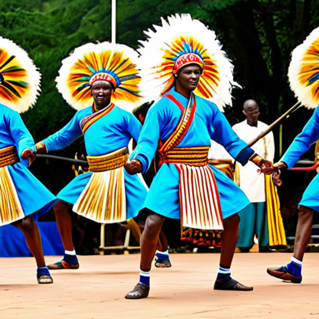 A group of Rwandan male Intore dancers, fully clothed in magnificent, vibrant traditional costumes featuring long, flowing fiber headpieces reminiscent of lion manes and decorated ceremonial shields. They are captured mid-dynamic movement on a simple outdoor stage, performing powerful and elegant warrior dance steps, embodying strength and cultural pride. The background shows a lively cultural festival atmosphere under natural lighting. Perfect anatomy, correct proportions, natural pose, well-formed hands, proper finger count, natural body proportions, safe for work, appropriate content, fully clothed, professional, high quality, professional photography, family-friendly.
